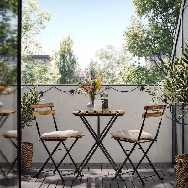 TÄRNÖ Table+2 chairs, outdoor, black/light brown stained foldable/foldable Kuddarna light grey-beige, 55x54 cm